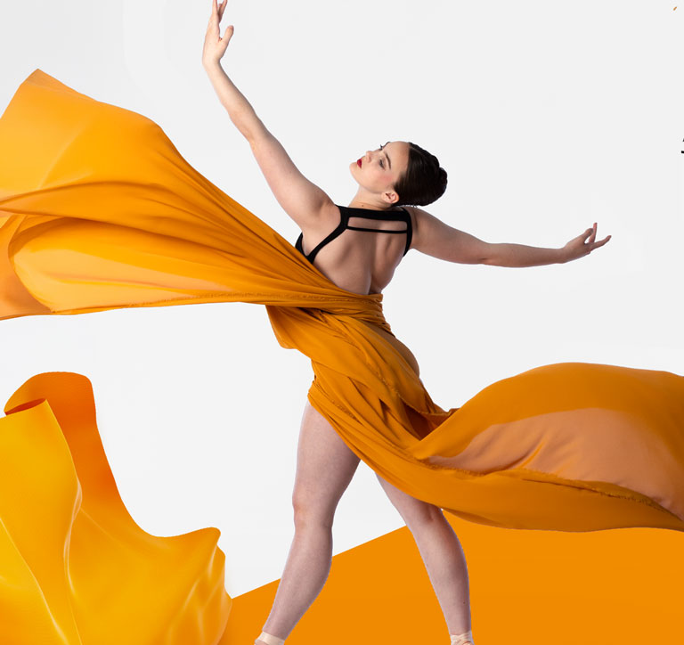 Woman dancing surrounded by flowing fabric