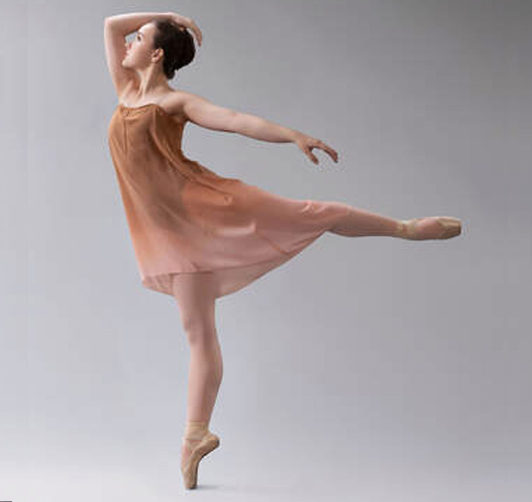 Dancer in pink skirt in arabesque